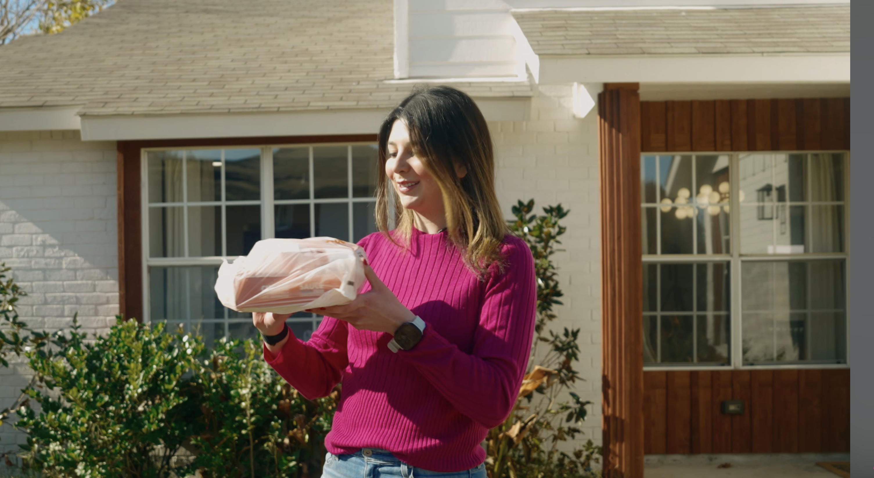 Jacklyn receiving a drone delivery at her door